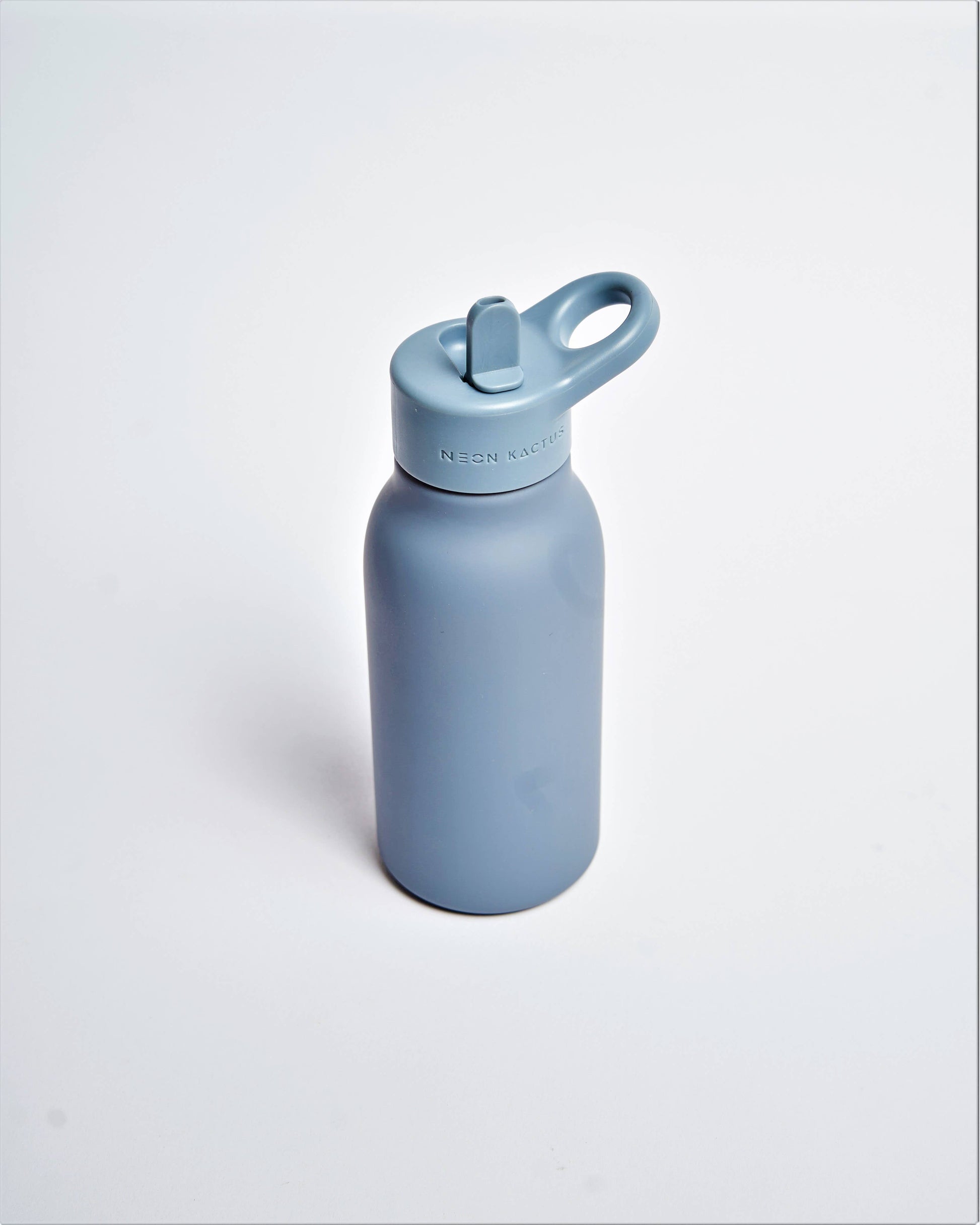 Blue water bottle with a white cap on a light gray background