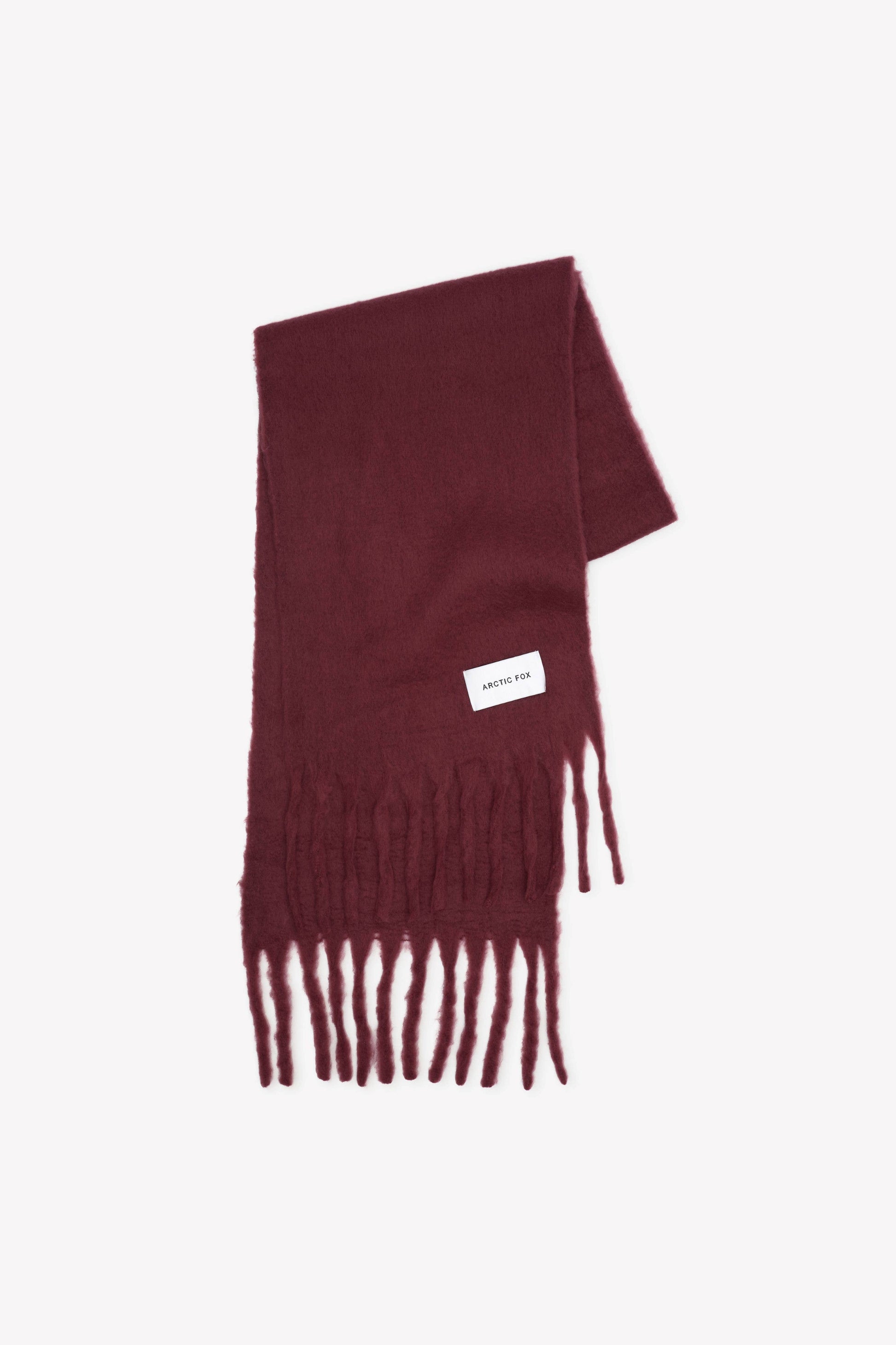 Burgundy scarf with fringes on a white background
